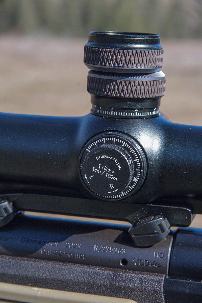 Elevation and windage corrections are made in metric 1 centimeter at 100 meters increments, with the windage dial covered and the elevation knob exposed.